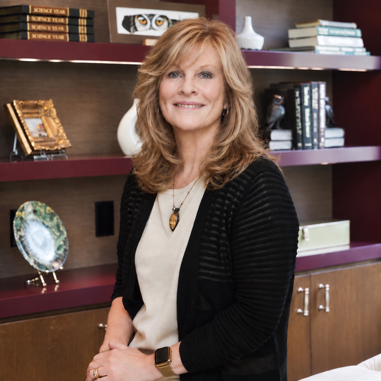 Nancy Sheppard, founder of Women2Boards, seated in front of bookshelves